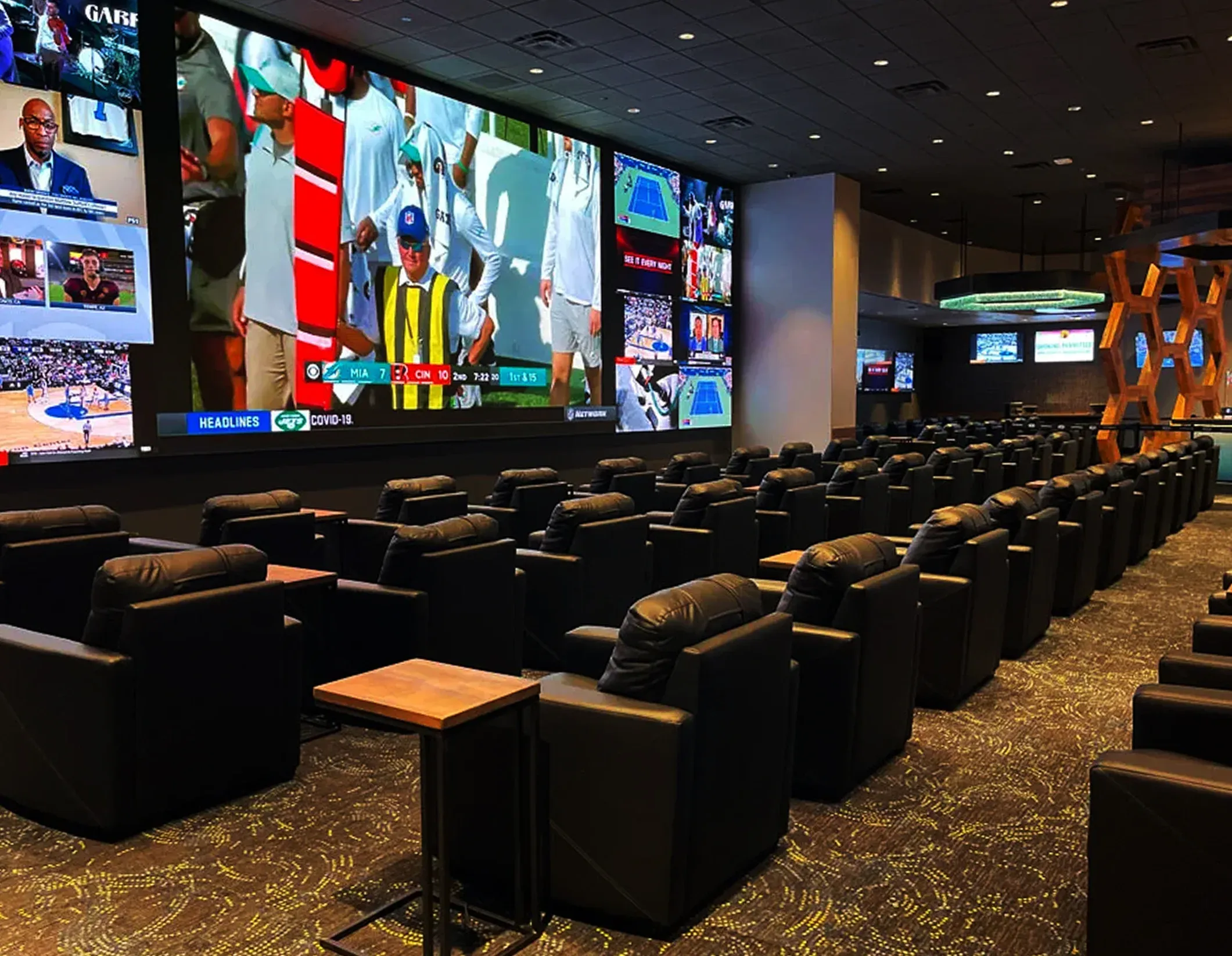 EQC sports betting lounge — wall of screens and recliner seating
