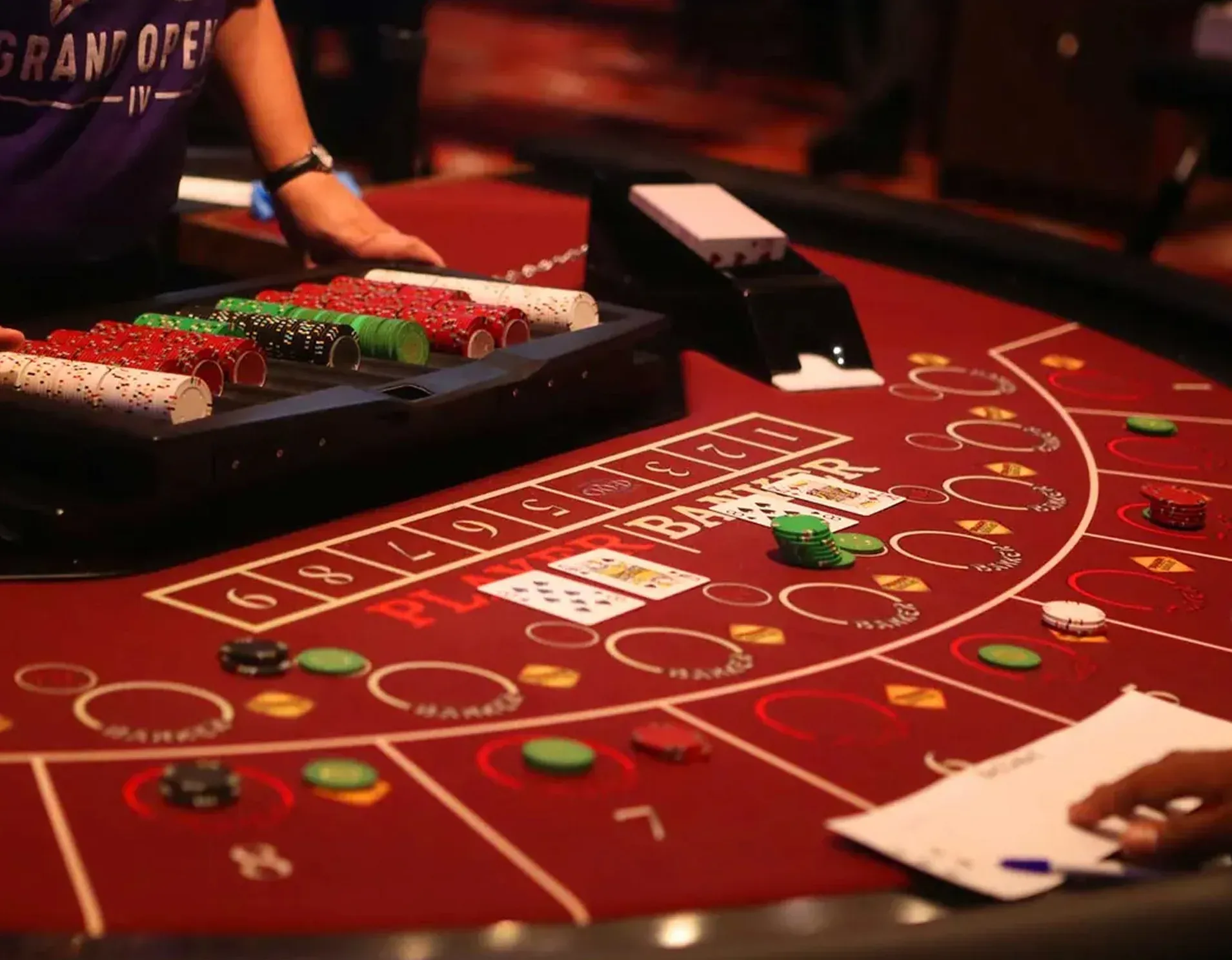 EQC table games — baccarat table with chips and cards