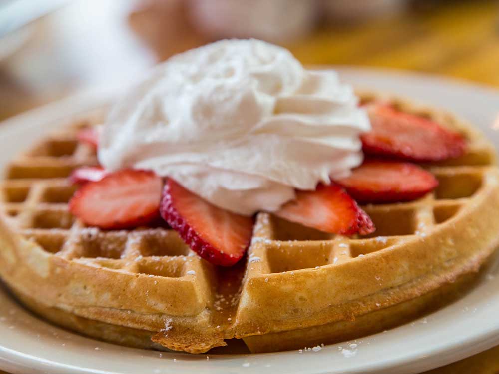 Waffle with strawberries and whipped cream