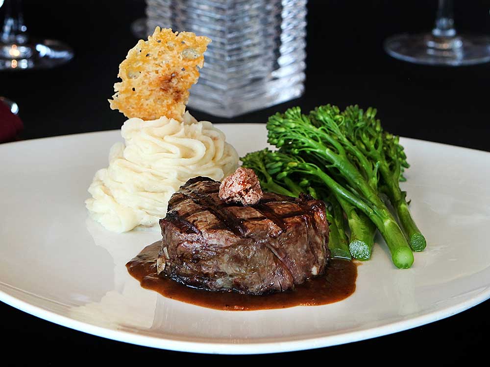 Filet on a platter with asparagus and potatoes